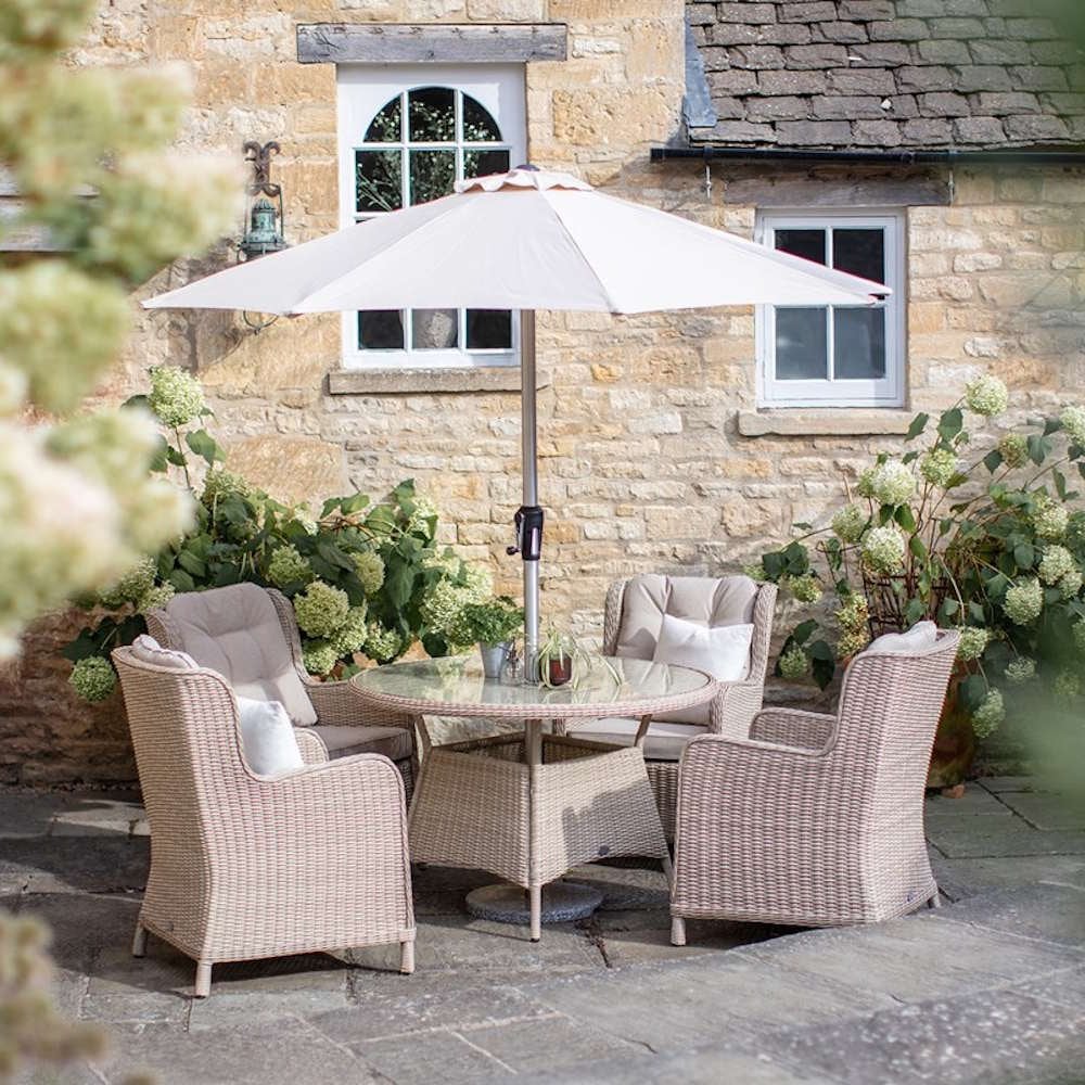 Bramblecrest Chedworth 4 Seat Garden Dining Set in Sandstone with Round Table, Parasol & Base