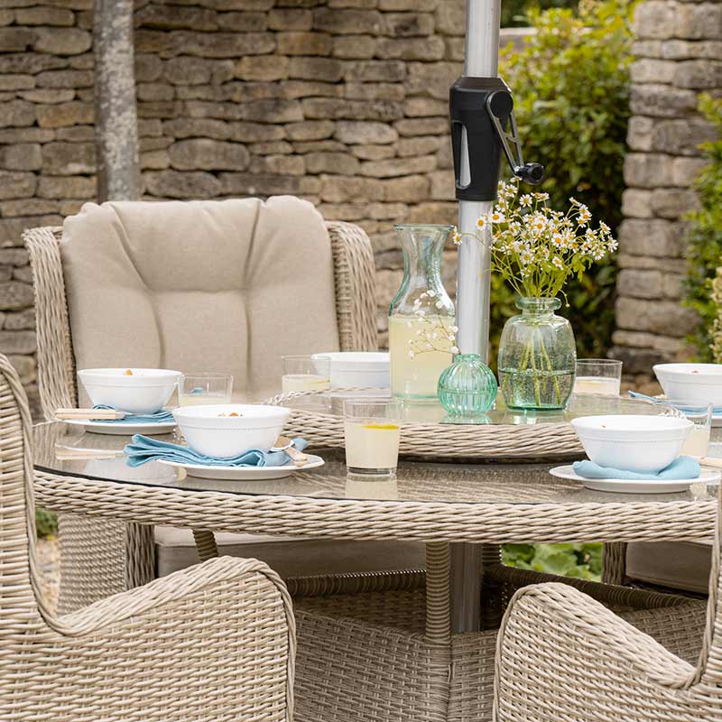 Bramblecrest Chedworth 6 Seat Garden Dining Set in Sandstone with Round Table, Lazy Susan, 3m Parasol & Base