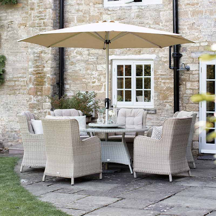 Bramblecrest Chedworth 6 Seat Garden Dining Set in Sandstone with Round Table, Lazy Susan, 3m Parasol & Base