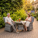 Mid Ulster Garden Centre Bali 2-seat bistro set with light brown synthetic rattan chairs and a round glass-top table.