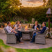 Mid Ulster Garden Centre Bali 4 seat rattan dining set with round glass table and cushions in a lush garden setting.
