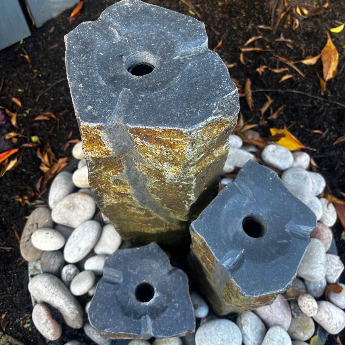 Mid Ulster Garden Centre hand carved basalt trio water feature with three natural stone columns and river pebbles