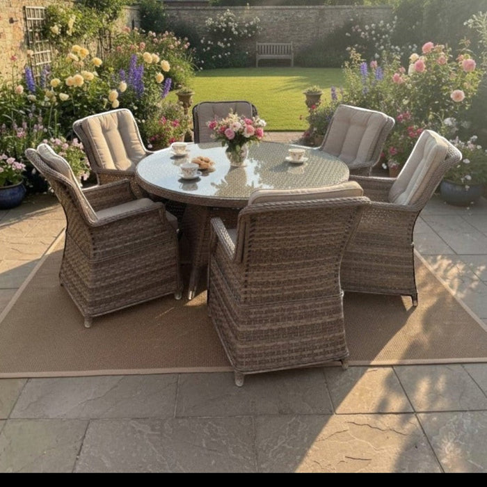 Mid Ulster Garden Centre Hampton 6 seat round rattan dining set with beige cushions in a lush flower garden